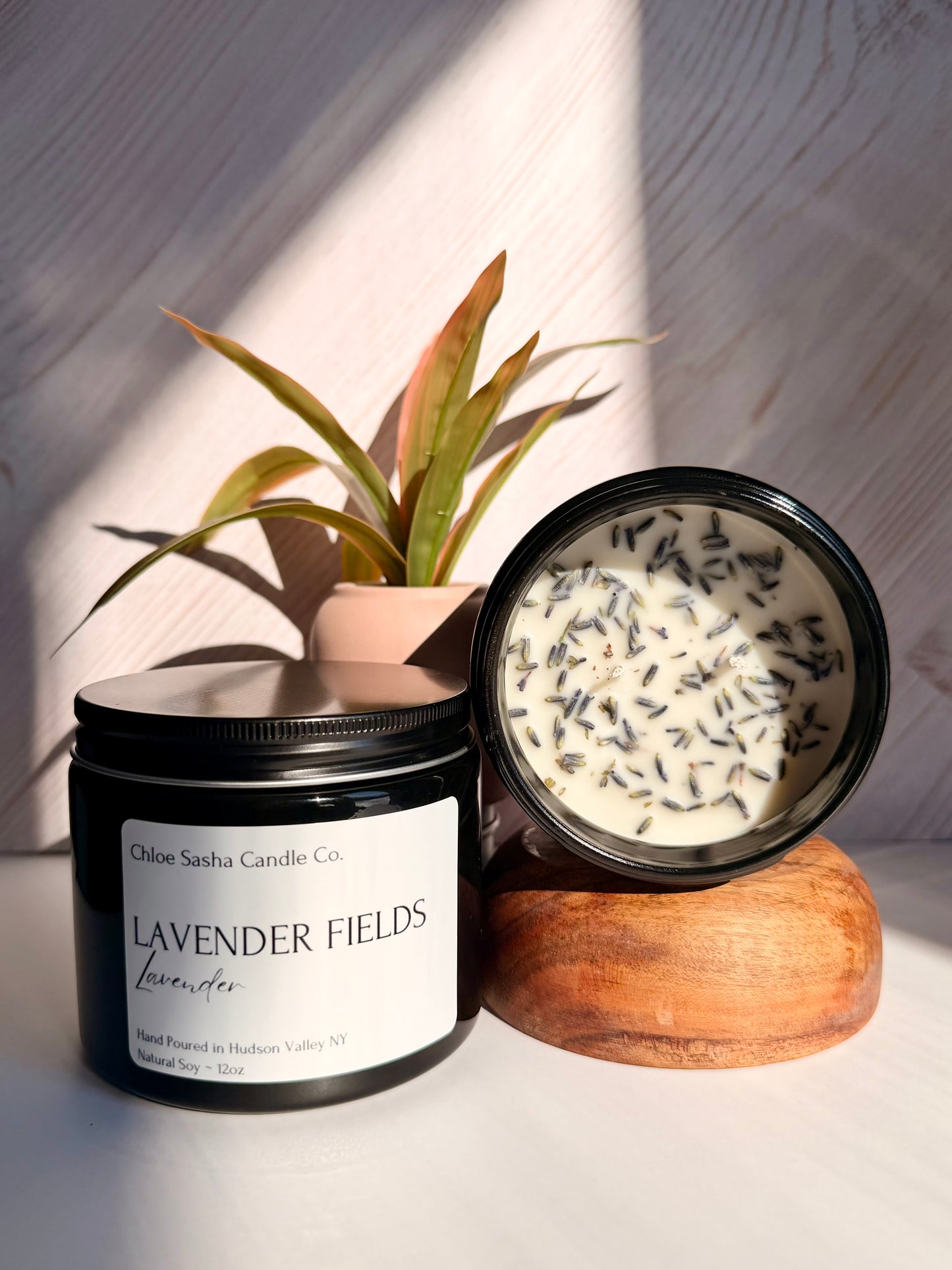 Lavendar hand poured natural soy candle. Lavender Fields captures the essence of this timeless, beautiful flower, beautifully enhanced with bright notes of citrus, camphor, and eucalyptus for a fresh, true-to-life lavender experience, especially enhanced with farm fresh lavender buds added for that extra touch.