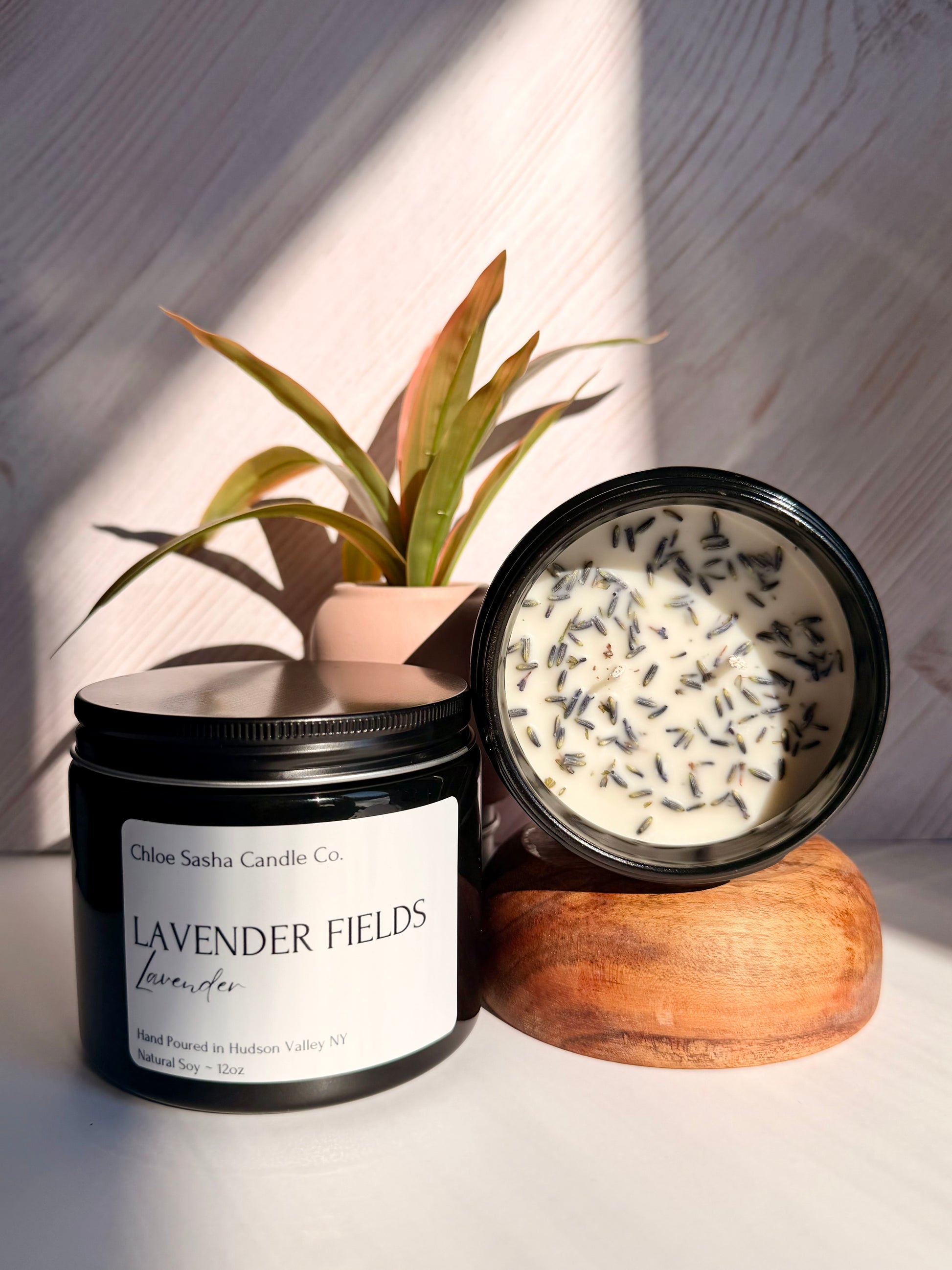 Lavendar hand poured natural soy candle. Lavender Fields captures the essence of this timeless, beautiful flower, beautifully enhanced with bright notes of citrus, camphor, and eucalyptus for a fresh, true-to-life lavender experience, especially enhanced with farm fresh lavender buds added for that extra touch.