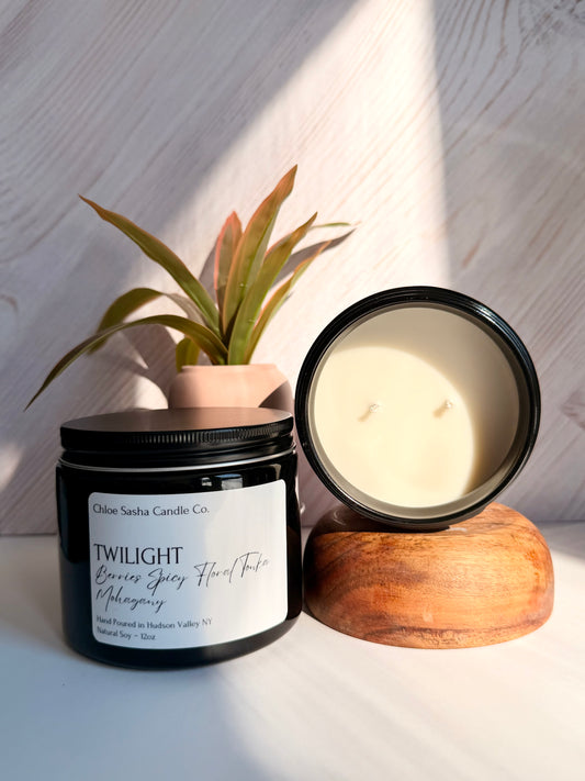 Twilight a blend of berries, floral and tonka hand poured natural soy candle. An opulent fragrance that enchants, exudes sophistication, and draws you in with effortless allure. This lavish indulgence marries the juicy burst of pomegranates and wild berries with tantalizing spicy florals and the comforting embrace of warm, soothing woods. An exotic, elevated blend that infuses your space with timeless luxury. Notes of Berries, Spicy Floral, Sandalwood & Teakwood. Pearlized white shimmer upon melting.